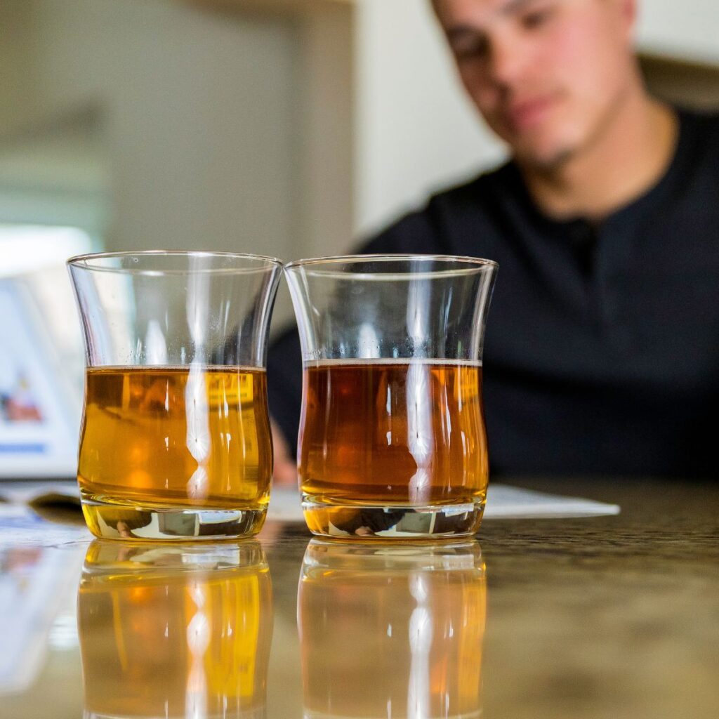 brown water in a glass as a tech explains the causes