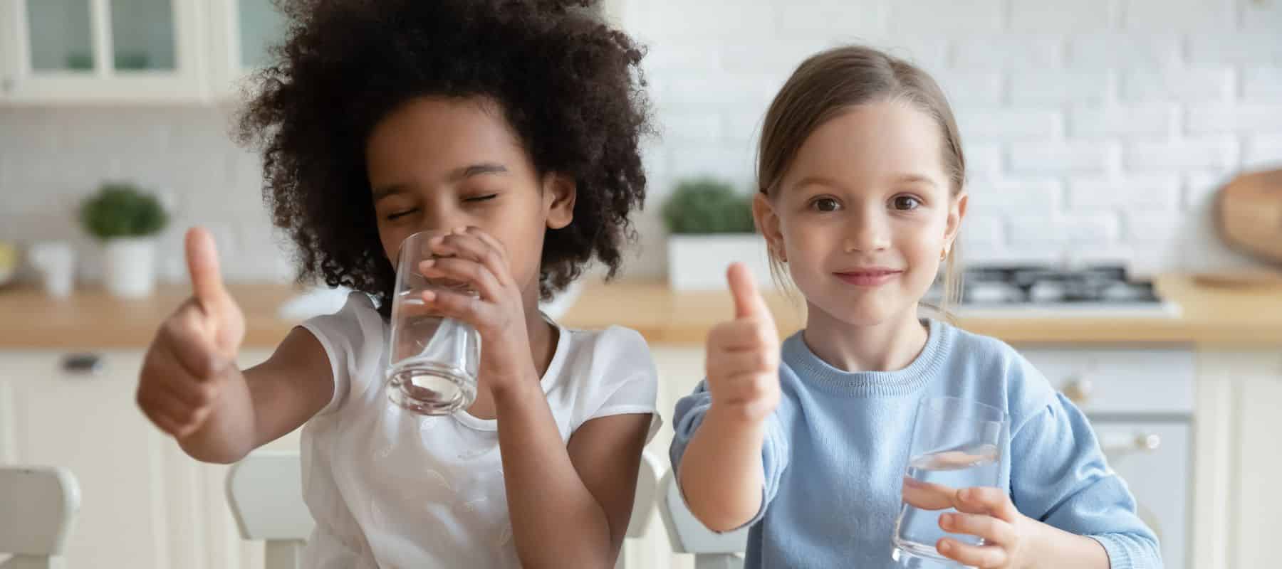 two children doing a thumbs up