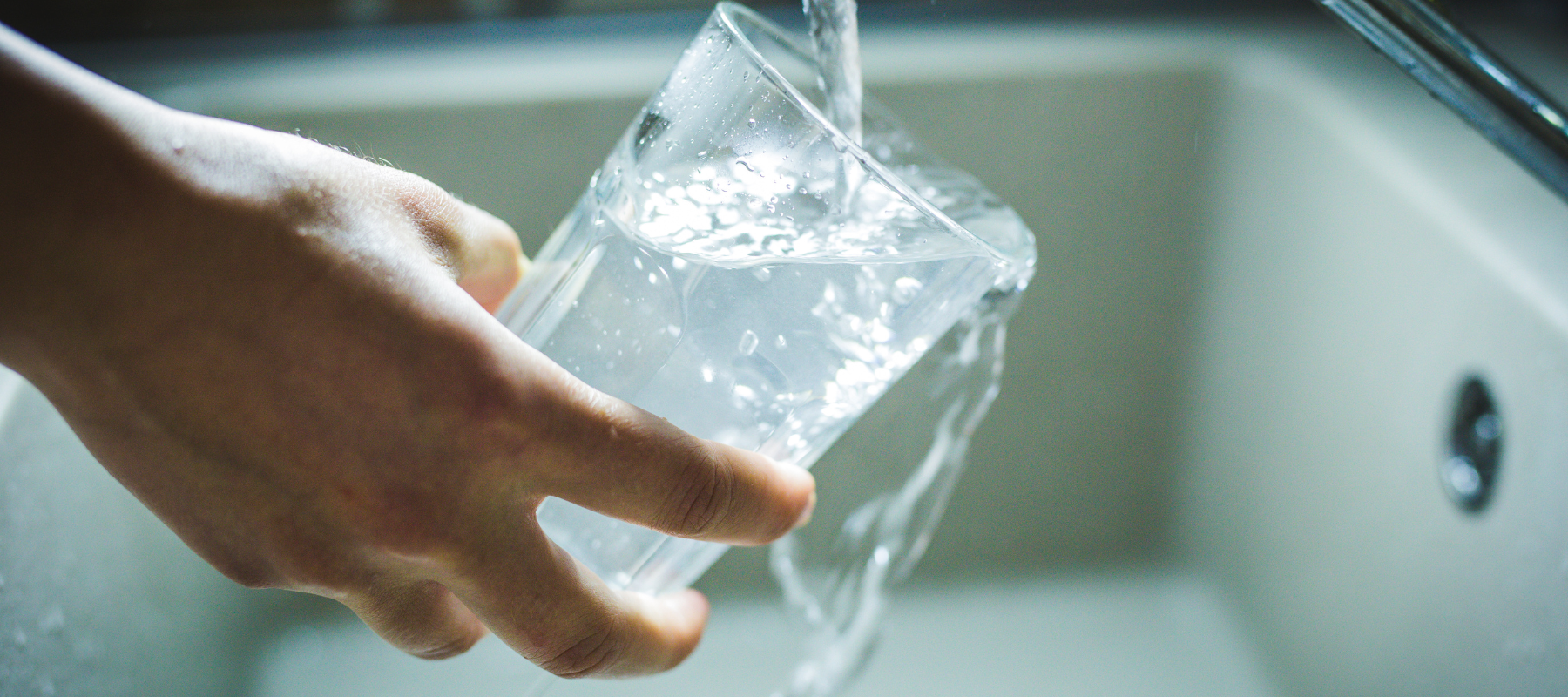 drinking water in the sink leaks off hands.